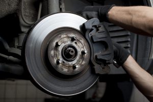 Closeup of car mechanic repairing brake pads